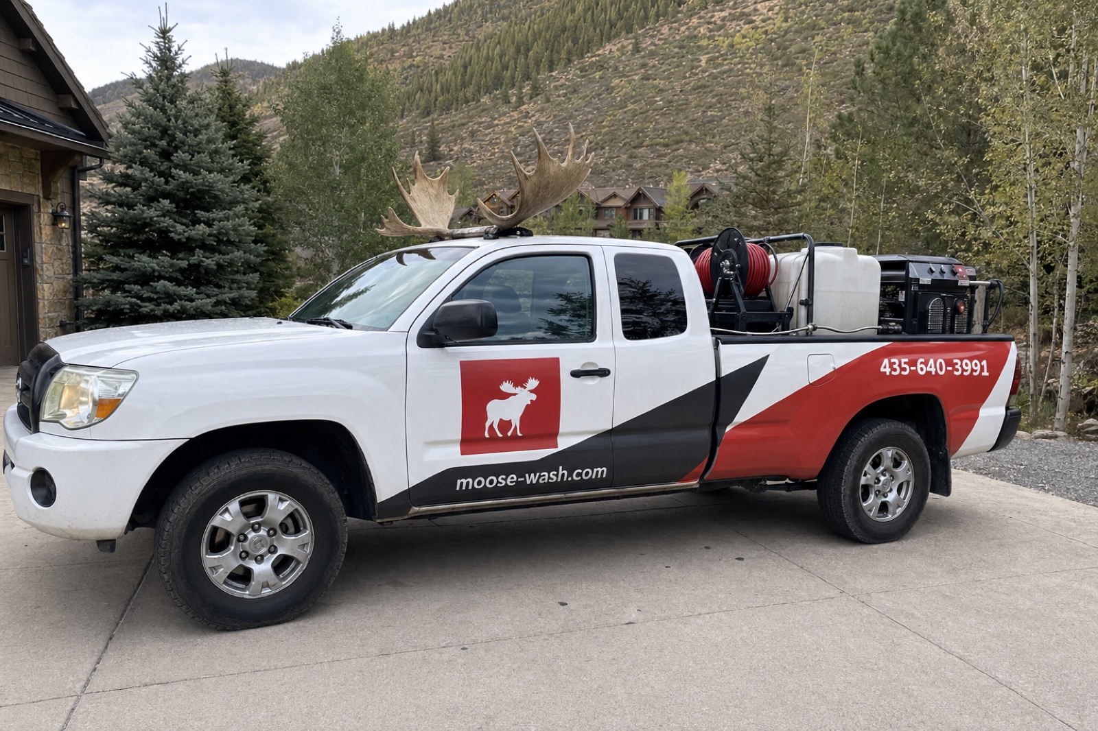White MooseWash work truck with pressure washing equipment